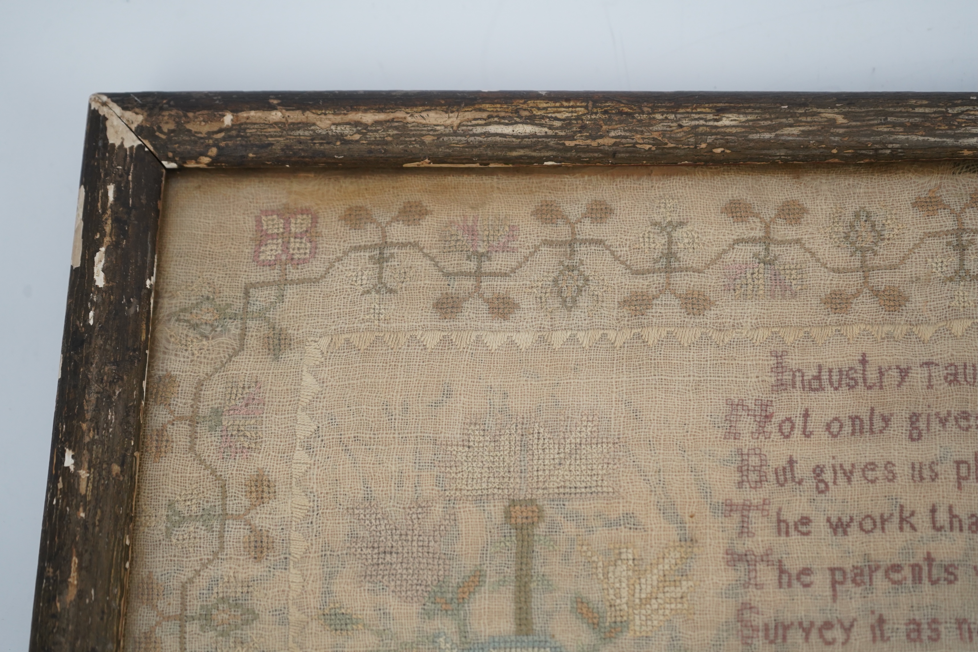 A gilt framed finely worked Regency gauze sampler, by Amelia Artus, aged 8 years, dated 1813, worked on fine gauze with coloured silk threads, with a large central panel having a long verse, two motifs of cornucopia, pot